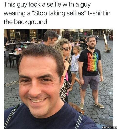This guy took a selfie with a guy wearing a stop taking selfies tshirt in the ba