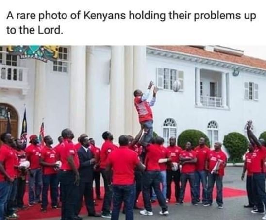 A rare photo of kenyans holding their problems up to the lord.
