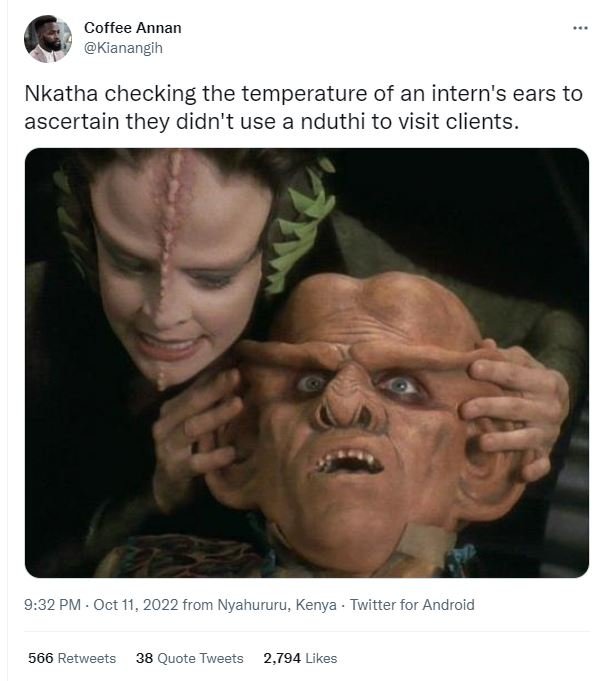 Coffee annan kianangih nkatha checking the temperature of an intern's ears to as