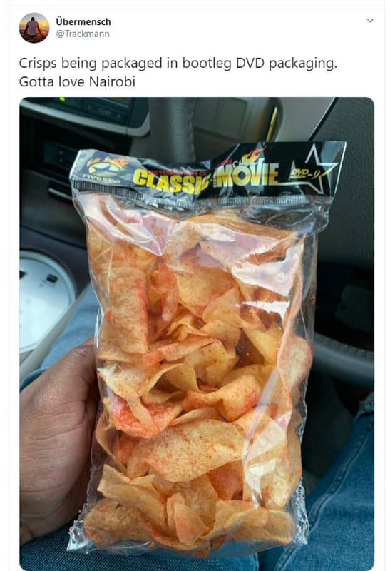 Übermensch trackmann crisps being packaged in bootleg dvd packaging. gotta love